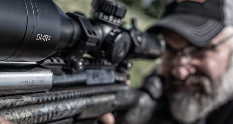 Shooter aiming through Elite Tactical DMR3 Riflescope